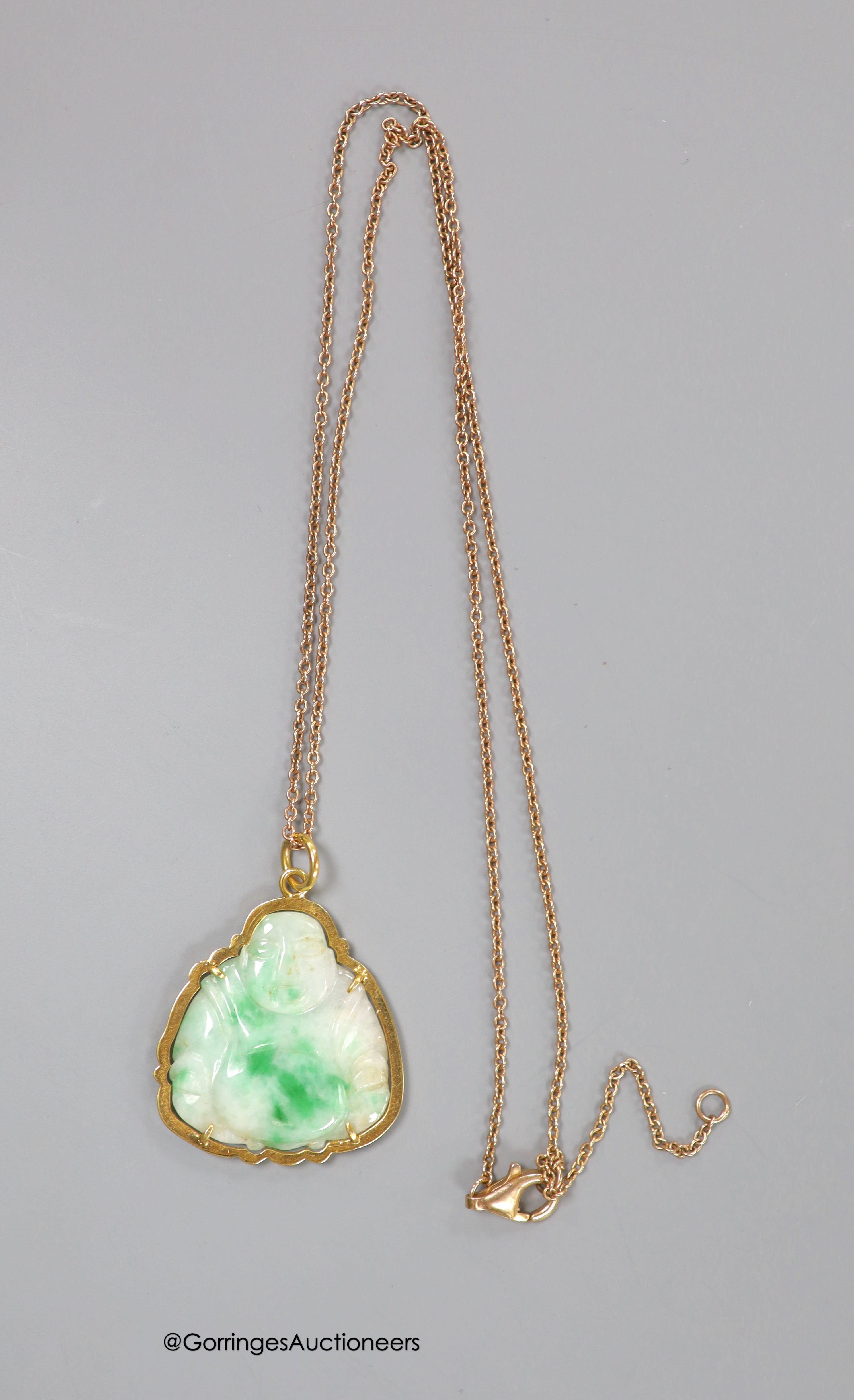 A yellow metal mounted jade pendant, carved as a Buddha, 30mm on a 925 chain.